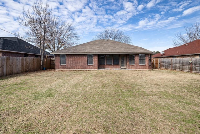 rear view of house with a lawn