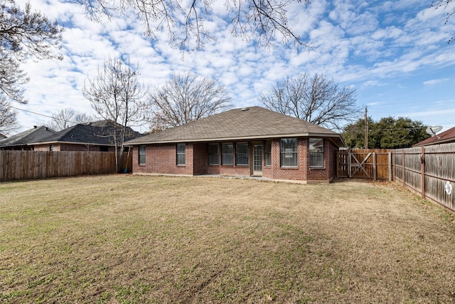 back of property featuring a lawn