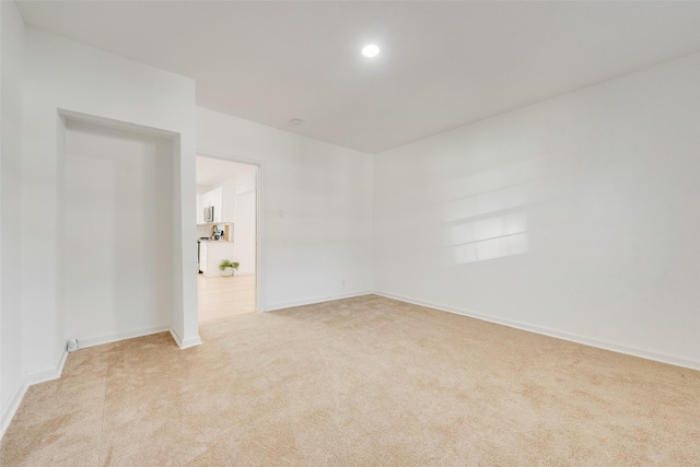 spare room with light colored carpet