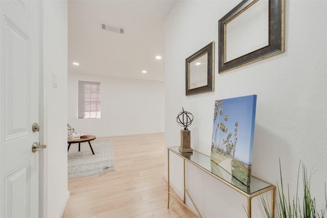 corridor with light hardwood / wood-style floors