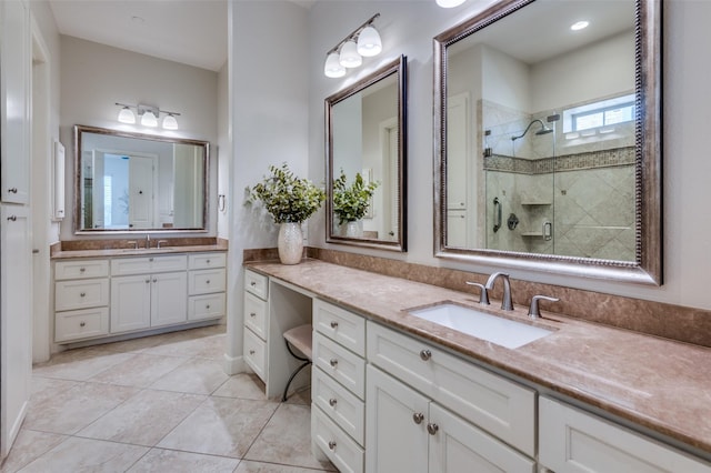 bathroom featuring vanity, a shower with shower door, and tile patterned floors