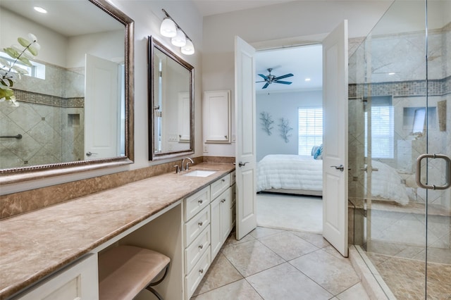 bathroom featuring ceiling fan, vanity, an enclosed shower, and tile patterned floors