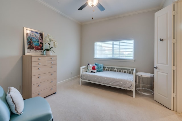 carpeted bedroom with ceiling fan and ornamental molding