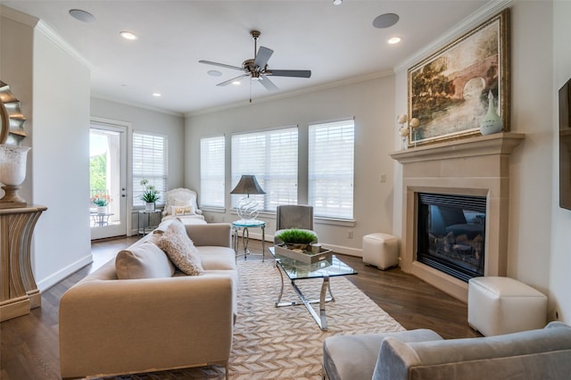 living room featuring a healthy amount of sunlight, dark hardwood / wood-style floors, and ornamental molding