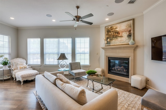 living room with crown molding, dark hardwood / wood-style floors, and ceiling fan