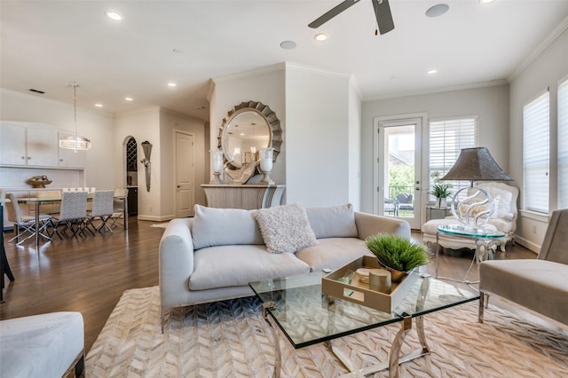 living room with crown molding, ceiling fan, and light hardwood / wood-style flooring