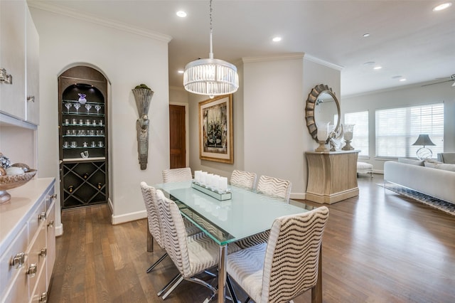 dining area featuring ornamental molding and dark hardwood / wood-style floors