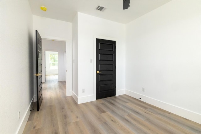 unfurnished room with light wood-type flooring and ceiling fan