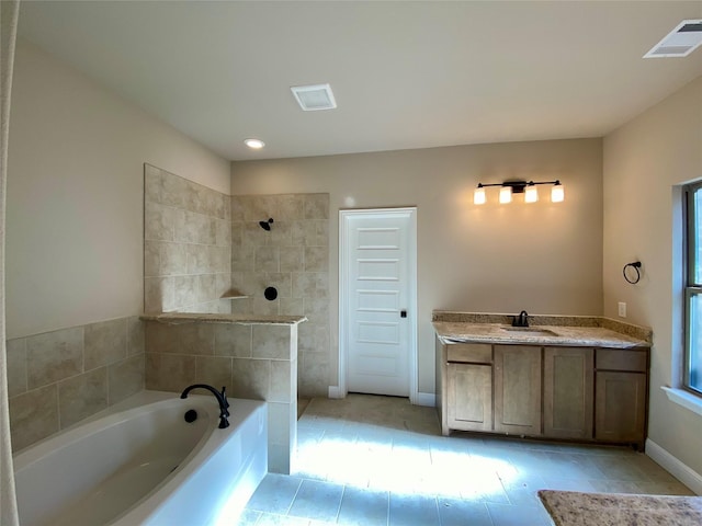 bathroom featuring tile patterned flooring, vanity, and shower with separate bathtub