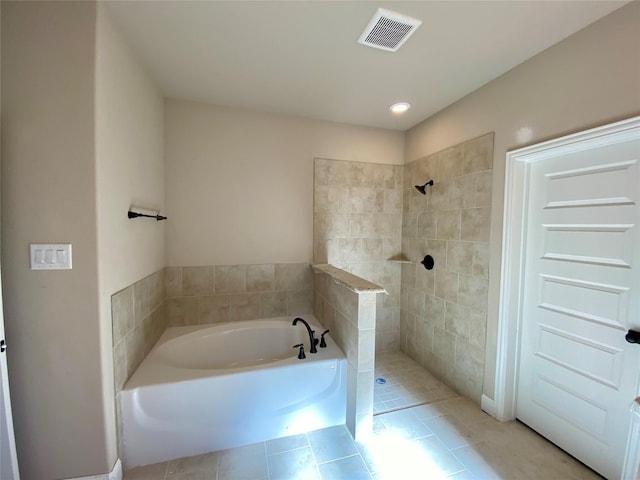 bathroom featuring plus walk in shower and tile patterned floors