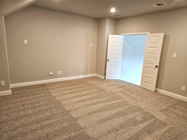 unfurnished room with lofted ceiling and carpet floors