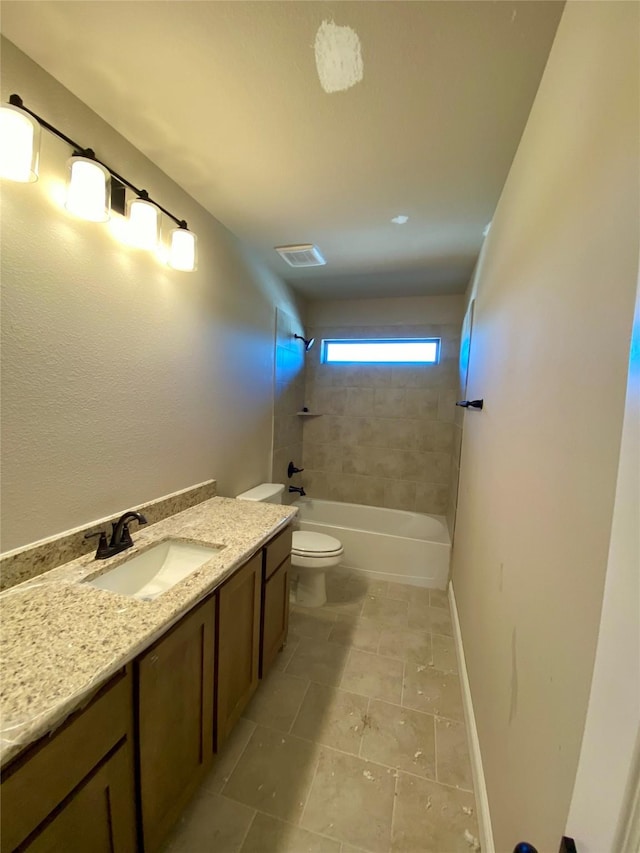 full bathroom with toilet, vanity, and tiled shower / bath combo