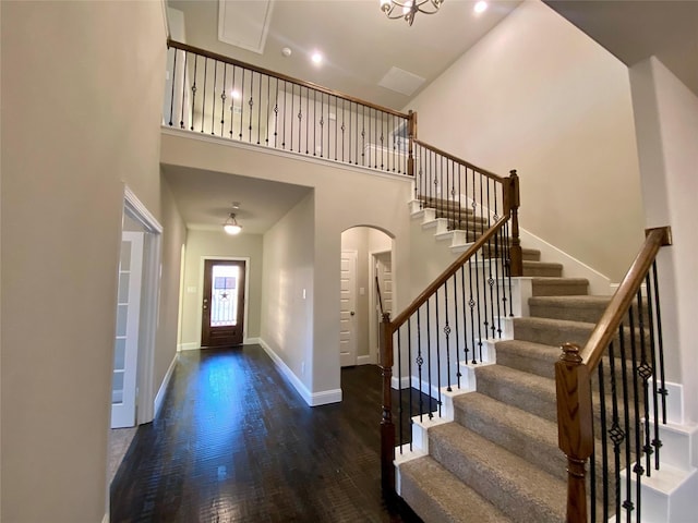 entryway with a high ceiling and dark hardwood / wood-style floors