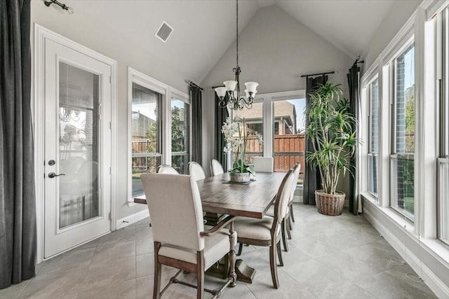 sunroom featuring a notable chandelier and vaulted ceiling