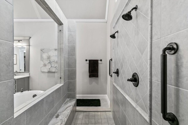 bathroom featuring tiled shower, vanity, and tile patterned floors