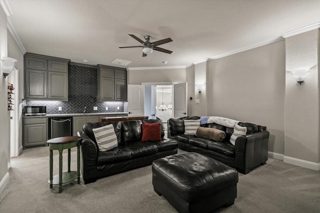 carpeted living room with ceiling fan, sink, and ornamental molding