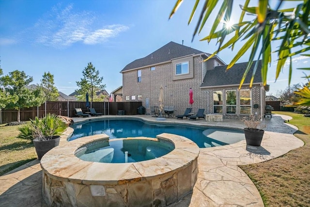 view of pool featuring a patio area and an in ground hot tub