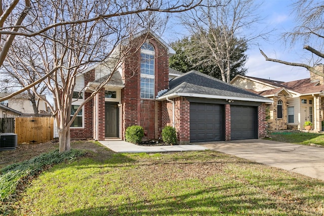 view of front of home with a garage, cooling unit, and a front yard