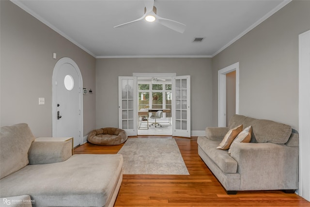 living room featuring french doors, ceiling fan, ornamental molding, and hardwood / wood-style floors