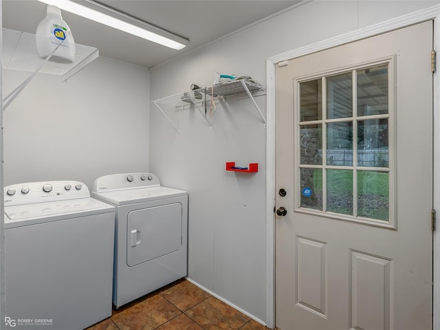 laundry room featuring dark tile patterned flooring and washing machine and clothes dryer