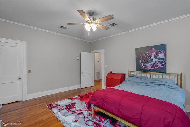 bedroom featuring wood-type flooring, ornamental molding, and ceiling fan