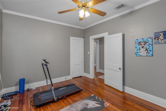 exercise room with wood-type flooring, ceiling fan, and crown molding