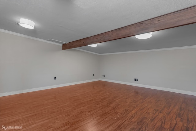 interior space with wood-type flooring, ornamental molding, and a textured ceiling