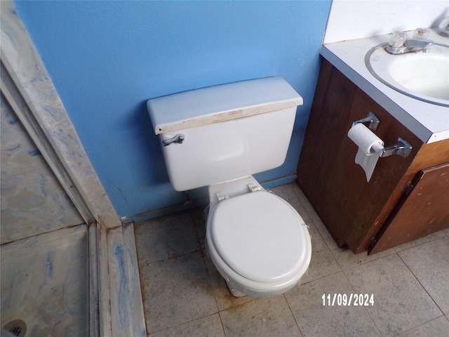 bathroom featuring tile patterned flooring, vanity, and toilet