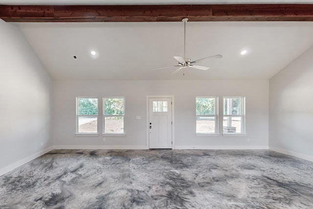 empty room featuring a wealth of natural light, lofted ceiling with beams, and ceiling fan