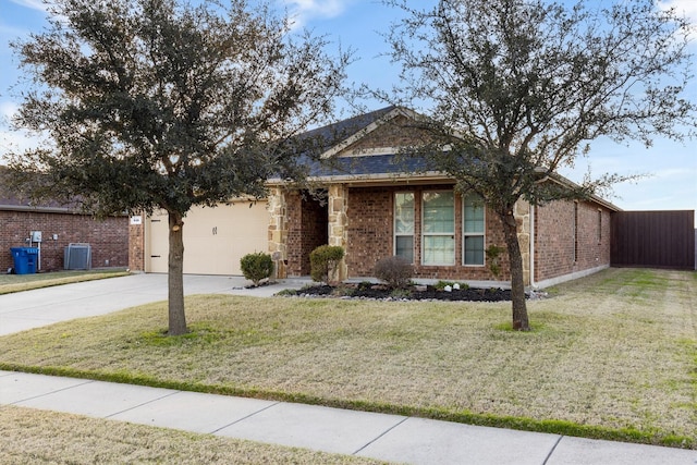 view of front of home with central air condition unit, a front yard, and a garage