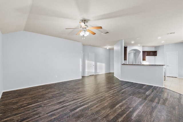 unfurnished living room featuring ceiling fan, dark hardwood / wood-style flooring, and lofted ceiling