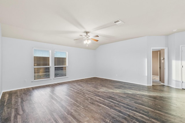 empty room with ceiling fan, dark hardwood / wood-style flooring, and lofted ceiling