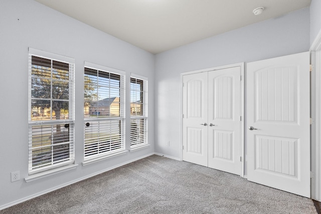 unfurnished bedroom with carpet floors and a closet