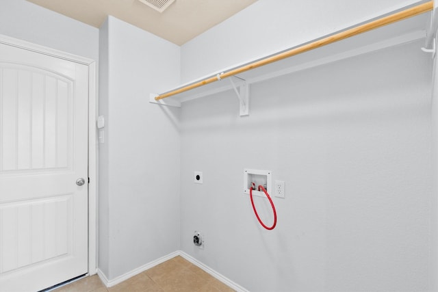 clothes washing area featuring electric dryer hookup, light tile patterned floors, and hookup for a washing machine