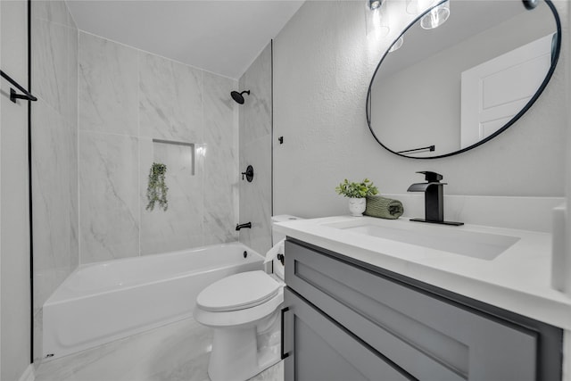 full bathroom featuring vanity, tiled shower / bath combo, and toilet