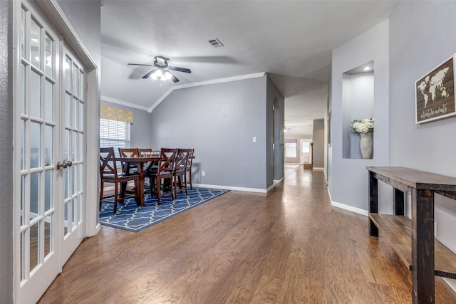 dining room featuring french doors, crown molding, wood-type flooring, vaulted ceiling, and ceiling fan