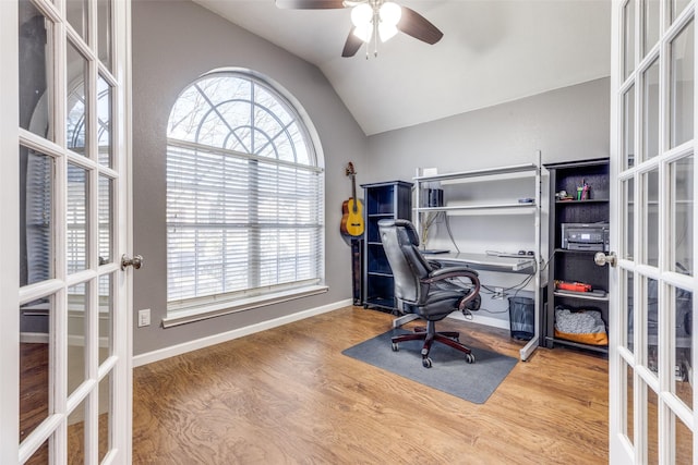 home office featuring vaulted ceiling, wood-type flooring, and french doors