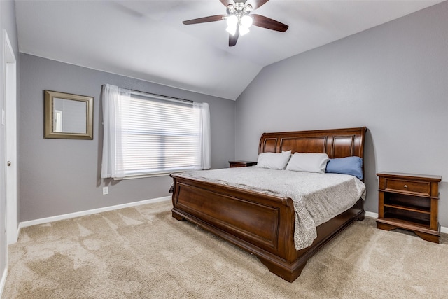 bedroom with vaulted ceiling, light carpet, and ceiling fan