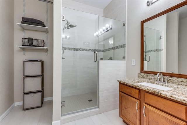 bathroom with vanity, tile patterned floors, and a shower with door