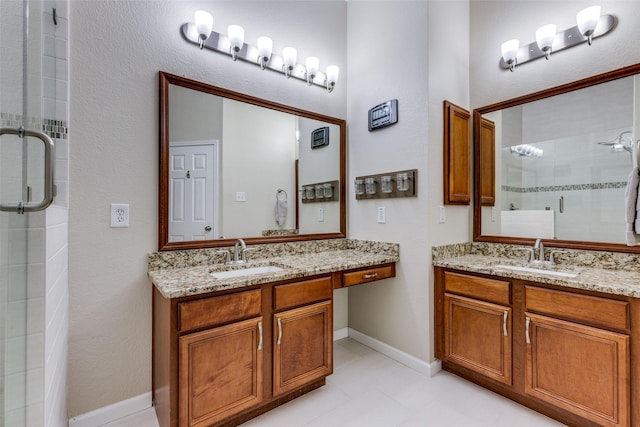 bathroom with vanity and a shower with shower door