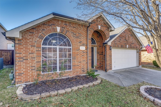 view of front of home featuring a garage and central air condition unit