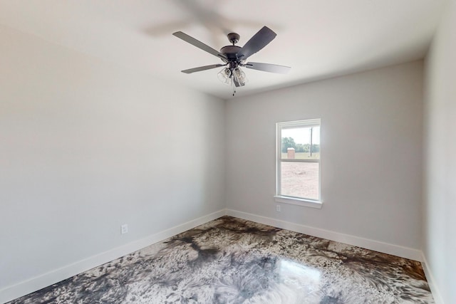 empty room featuring ceiling fan and concrete flooring