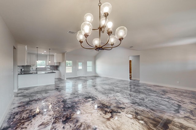 unfurnished living room with vaulted ceiling, sink, and an inviting chandelier