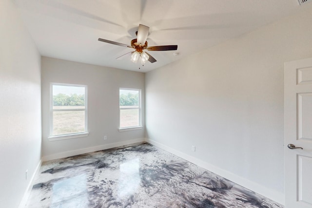 spare room featuring ceiling fan and concrete floors