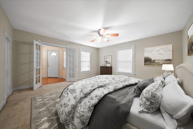 carpeted bedroom featuring ceiling fan and french doors