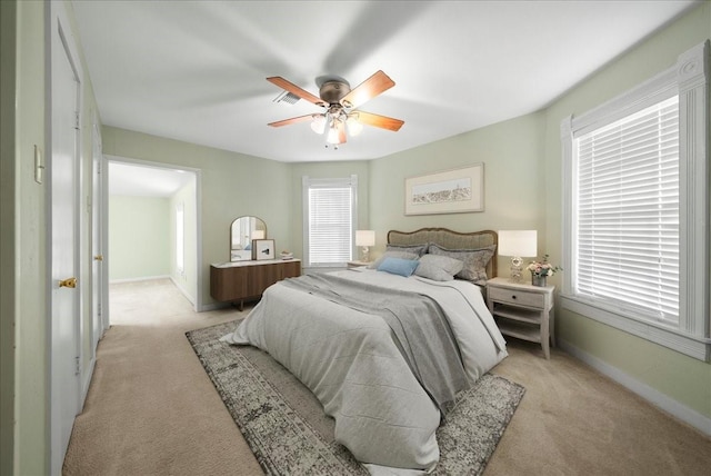 bedroom with light carpet and ceiling fan