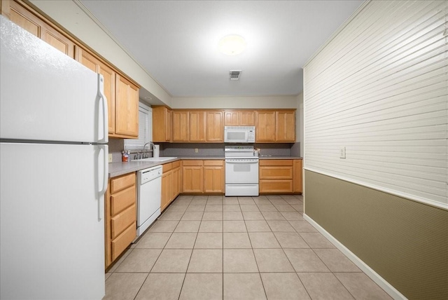 kitchen with light tile patterned floors, white appliances, and sink