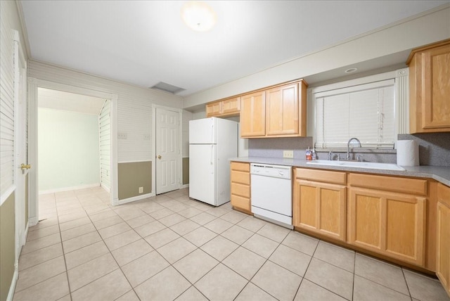 kitchen with sink, light tile patterned floors, white appliances, and light brown cabinets