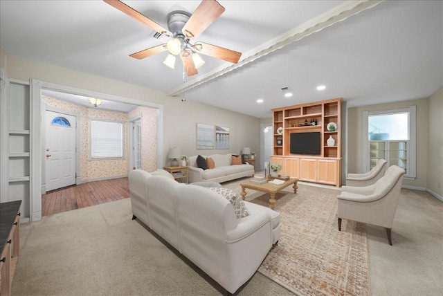 living room with ceiling fan and light carpet