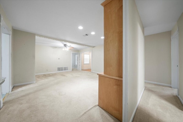 interior space featuring ceiling fan and light colored carpet